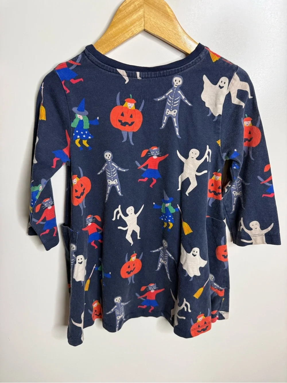 Mini Boden Halloween dress featuring pumpkins, ghosts, and skeletons, girls 5/6